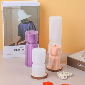 Detailed view of striped pillar candle silicone mold with DIY wax and plaster specimens