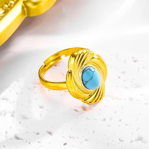 Detailed view of bohemian gold flower ring featuring a turquoise stone on a stone surface
