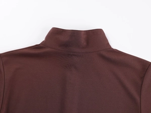 Detailed close-up of dark brown mock neck t-shirt with high-quality knitted fabric texture