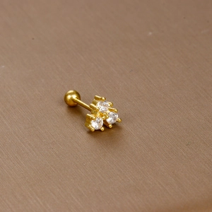 Close-up of gold stainless steel cartilage stud earring with three white zircons