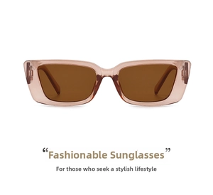 Detail view of pink transparent resin frame and dark brown lenses on retro sunglasses