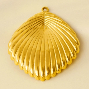 Macro shot of a golden shell pendant made of 304 stainless steel with textured details