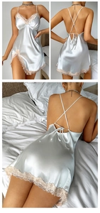 Detail of silk-like satin nightgown featuring lace trim V-neck and crisscross back design