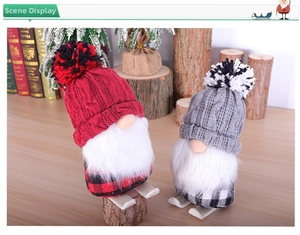 Detailed view of Christmas gnomes with knit hats and buffalo plaid on wooden skis