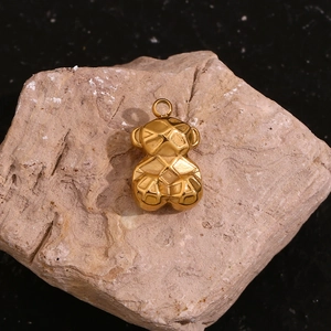 Macro shot of 18K gold plated stainless steel bear pendant with 3D geometric facets