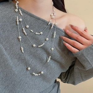 Close-up of elegant multi-layered pearl necklace with crystal-studded decorative beads
