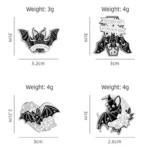 Set of four gothic Halloween bat enamel pins in black and silver with various spooky designs