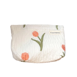 Portable white canvas makeup bag with tulip embroidery and minimalist textured design