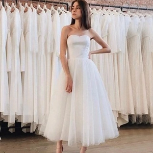 Elegant tea-length white strapless wedding dress with sweetheart neckline and tulle skirt