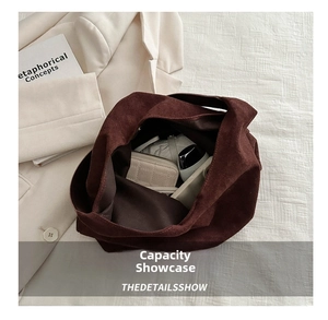 Deep brown matte tote bag interior showing large capacity with accessories