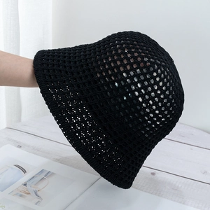 Close-up of black hollow crochet bucket hat showing breathable woven mesh texture