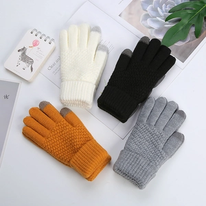 Flat lay view of four knit gloves in beige black yellow and grey with touchscreen fingertips