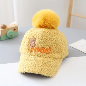 Detailed view of yellow teddy fleece kids baseball cap with fluffy pompom and bear embroidery