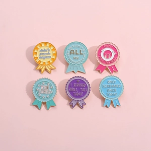 Colorful metal medal brooches set with humorous English quotes on a pink background