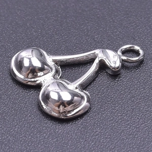 Detailed close-up of polished silver cherry pendant for DIY jewelry making