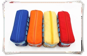 Top view of four colorful school bus canvas pencil cases in red, yellow, orange and blue
