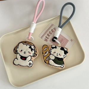 Detail of cute embroidered cat plush pendants with premium metal hooks for bags