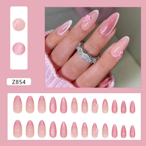 Pink cat eye press-on nails with 3D floral accents and French gradient almond shape