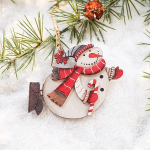 Nordic wooden snowman ornament with red scarf on snowy background for Christmas tree decor