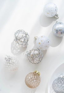 Close-up of gold and champagne 6cm PET Christmas balls with glitter star and mesh patterns