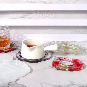 Detailed view of DIY irregular silicone coaster mold and resin coasters with dried flowers