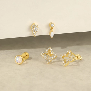 Detailed macro view of S925 sterling silver gold-plated earrings with zircon and opal stones