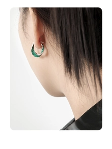 Close-up of S925 silver U-shape earrings with green marble texture on a model's ear
