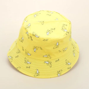 Close-up of yellow cotton bucket hat featuring all-over cartoon banana and eat text patterns