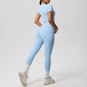Close-up of light blue yoga set featuring breathable short sleeve top and high waist leggings