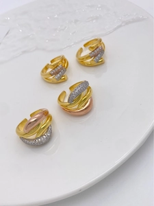 Detail of three-tone 18K gold plated multi-layer wrap rings with micro-set zircon stones