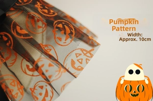 Close-up of Halloween pet lace cape with orange pumpkin pattern detail on black mesh fabric