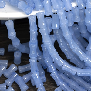 Macro detail of translucent blue bamboo-shaped glass beads for DIY jewelry making