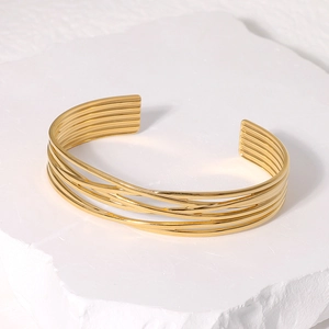 Macro shot of gold stainless steel multi-layer open bracelet with geometric lines