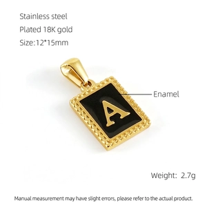 Macro detail of 18K gold plated stainless steel letter A pendant with black enamel