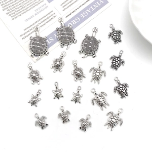 Macro view of assorted antique silver turtle alloy charms for DIY jewelry making crafts