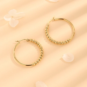 Gold stainless steel beaded hoop earrings with a polished finish for a modern look