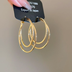 Detail view of 18k gold plated double layer hoop earrings showing S925 silver hallmark