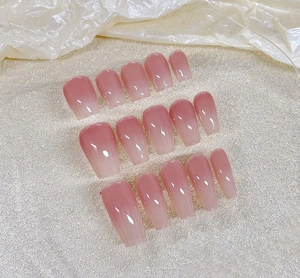 Detailed set of pink ombre coffin press-on nails with glossy gradient finish