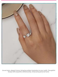 Close-up of silver open ring with three sparkling cubic zirconia flowers on a woman's hand