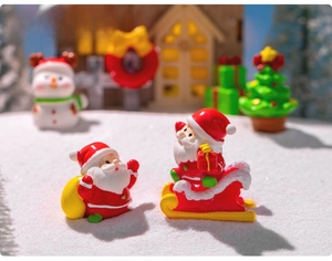 Miniature Christmas Santa Claus with red outfit and sled for festive micro landscape DIY