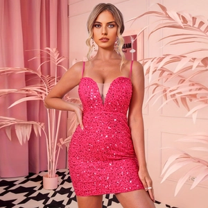 Detail of hot pink sequin mini dress featuring deep V-neck and sheer mesh patchwork