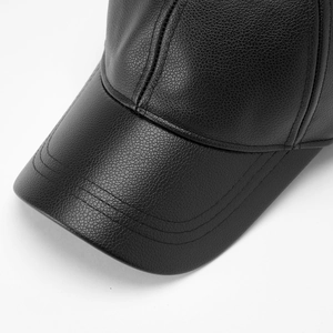 Close-up of black leather baseball cap texture with detailed three-line stitching craft