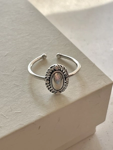 Close-up of vintage 925 sterling silver oval ring with spiral texture on display box