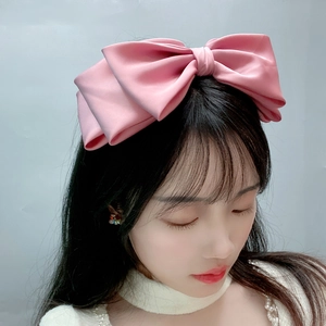 Pink oversized triple-layered satin bow headband for women featuring a silky glossy finish
