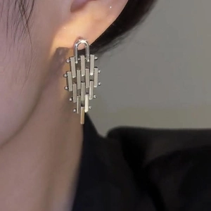 Silver geometric earrings with layered metal bars and spheres shown on a model
