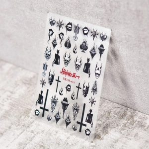 Detail of gothic nail stickers featuring skulls, blood fangs, and dark heart motifs