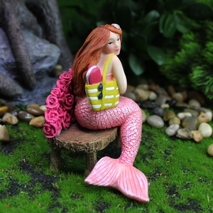 Creative resin mermaid figurine with pink tail sitting on wooden bench garden decor