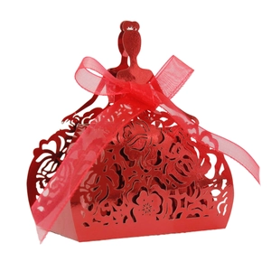 Detailed view of a red hollow-out paper candy box with elegant ribbon decoration