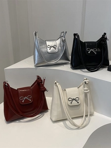 Minimalist underarm bags in silver, black, burgundy, and off-white with metal bow detail