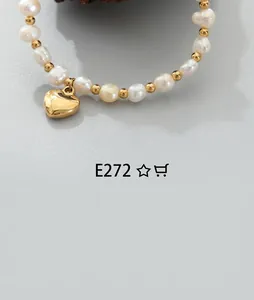 Macro detail of natural irregular pearls and gold beads with a heart pendant
